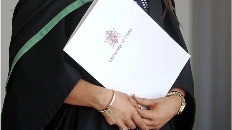 A recent graduate holding her certificate which displays &#39;University of Ulster&#39; logo. Picture: Hugh Russell. 