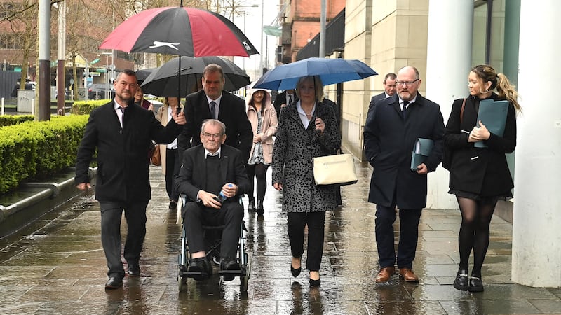Kingsmill massacre survivor Alan Black, front, and Karen Armstrong, centre, the sister of victim John McConville, with friends and supporters of the victims arriving at Laganside Courts, Belfast