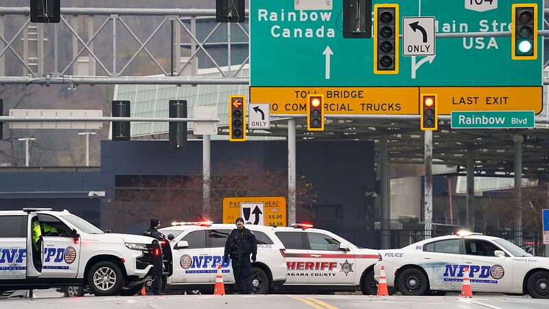 Law enforcement personnel block off the entrance to the Rainbow Bridge (Derek Gee/AP)