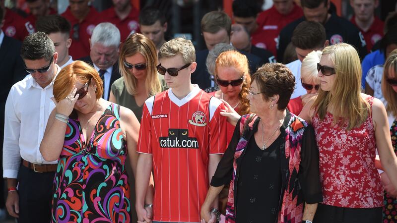 &nbsp;Susie Evans (left) and Owen Richards (second left) observe a minute's silence at the Banks's stadium in Walsall in memory of the victims of the Tunisia terror attack which claimed the lives of their relatives Patrick Evans, Adrian Evans and Joel Richards.
