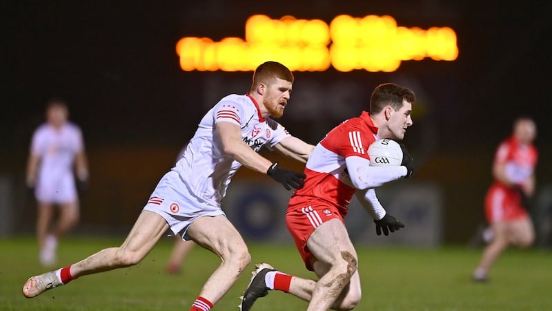 Derry’s Padraig McGrogan attempts to escape the attentions of Tyrone forward Cathal McShane during last night’s Dr McKenna Cup clash at Owenbeg. Picture by Sportsfile