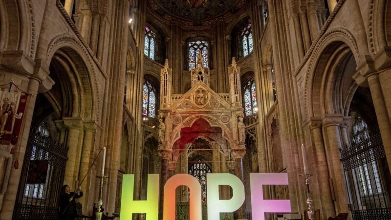 Canon Sarah Brown lights a candle next to a multicoloured &#39;Hope&#39; sign in Peterborough Cathedral to mark the opening of a &#39;Covid-19: All we have lost&#39; prayer trail, which has been created to help people find space to lament and acknowledge the multiple effects of the coronavirus pandemic on their lives, both individually and as a community. Picture by Joe Giddens/PA Wire 