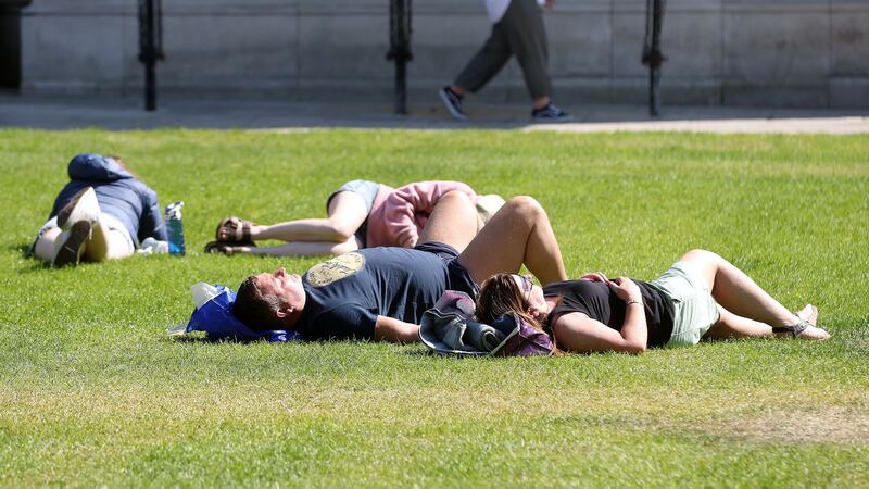 The sun keeps shining: A relaxing evening on the first day of summer at Belfast City Hall. Picture Mal McCann