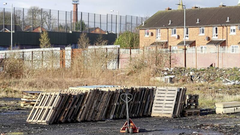 Pallets and tyres being collected waste ground in the Shankill area near the peaceline at Cupar Way Picture Mal McCann. 