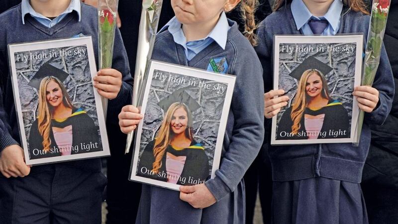 Pupils from Ashling Murphy&#39;s class hold photographs of the murdered schoolteacher at her funeral in Co Offaly on Wednesday. The 23-year-old was found dead after going for a run on the banks of the Grand Canal in Tullamore. 