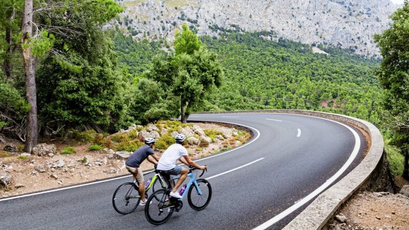 Cyclists ride up the Puig Major peak in Mallorca, Spain 