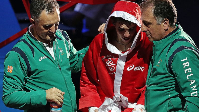 Former Irish head coach Billy Walsh consoles Michael Conlan after his 2012 Olympic semi-final loss to Robeisy Ramirez. Picture by PA