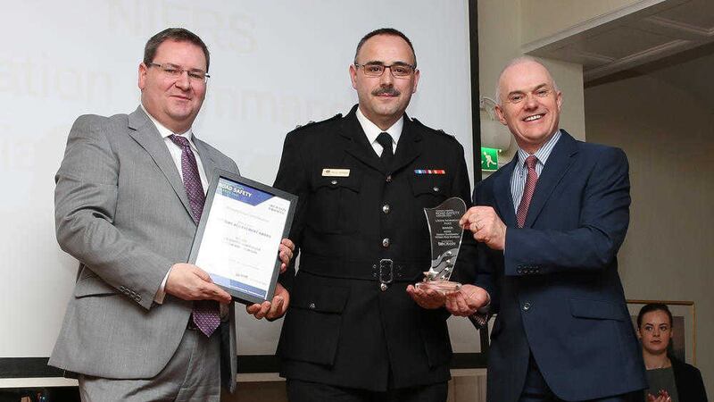 Station Commander Rory Dumigan from the NI Fire &amp; Rescue Service is presented with the inaugural Lifetime Achievement Award at the Northern Ireland Road Safety Awards by Jonathan McKeown of CRASH Services and U105 presenter Frank Mitchell 