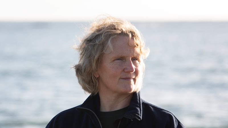 Novelist Roisin Maguire standing infront of the sea