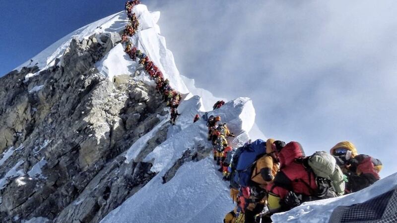 Along queue of mountain climbers line a path on Mount Everest Picture by Nimsdai Project Possible via AP 