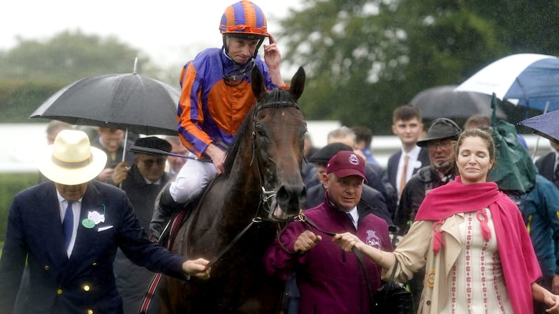 Paddington, ridden by Ryan Moore, is led into the winners' enclosure after victory in the Qatar Sussex Stakes on Wednesday