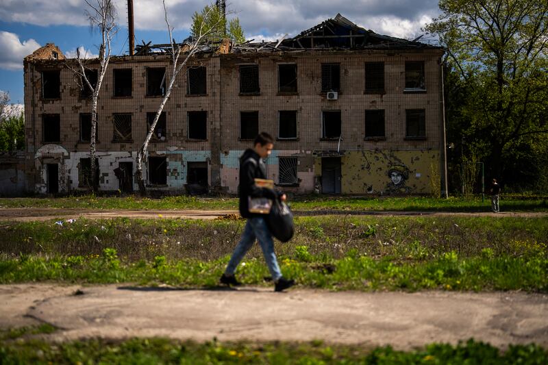 A man walks past a building partially destroyed in Russian attacks in Borodyanka, north of Kyiv (Francisco Seco/AP)