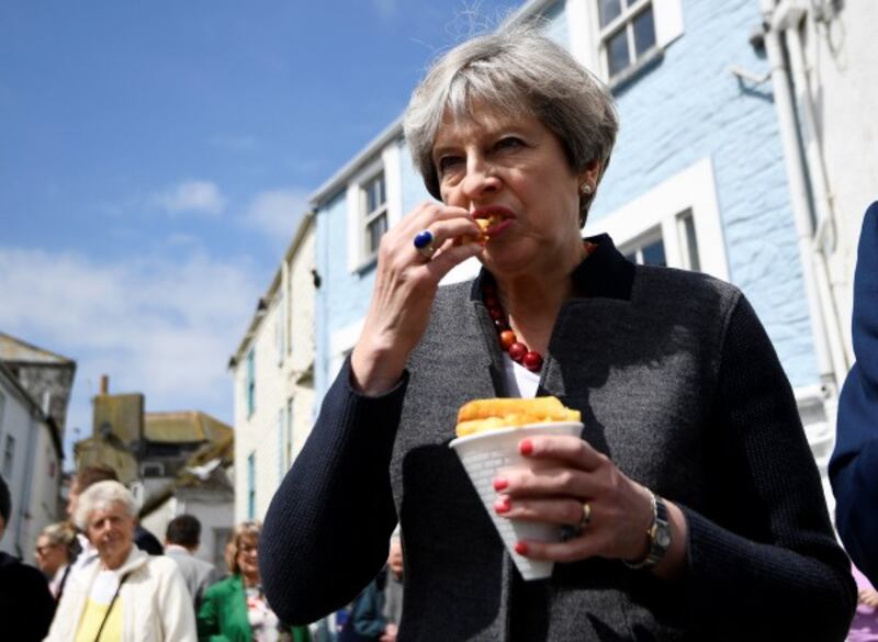 Prime Minister Theresa May having some chips while on a walkabout during an election campaign stop in Mevagissey, Cornwall.