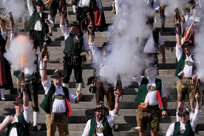 Bavarian riflemen and women in traditional costumes fire their muzzle loaders on the last day of the Oktoberfest beer festival in Munich last October (Matthias Schrader/AP)