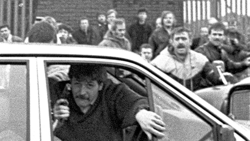 Corporal Derek Woods emerging from his car with his gun in hand after driving into the funeral of Caoimh&iacute;n MacBr&aacute;daigh who had been shot dead by loyalist Michael Stone