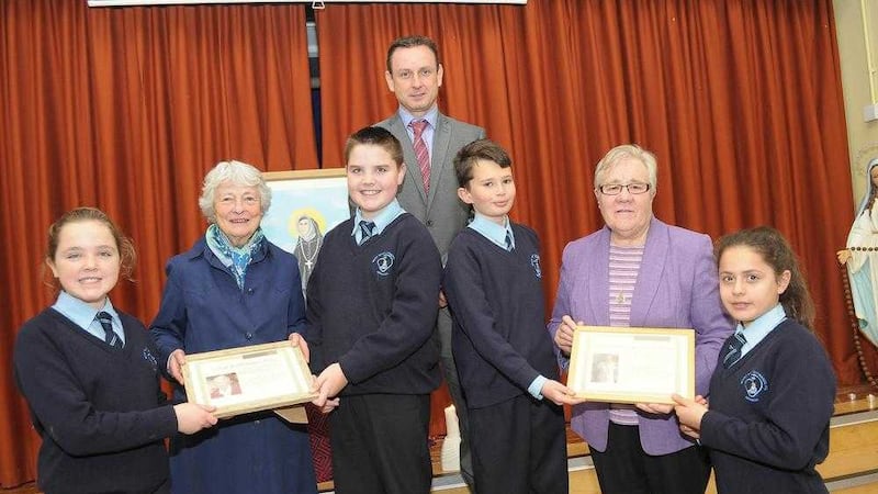 Pupils at Mount St Catherine&#39;s Primary School in Armagh have marked the Year of Consecrated Life by making a presentation to the Sacred Heart Sisters. With the pupils are headmaster Peter Gildea and Sr Kathleen Friel, pictured left, and Sr Bernadette McArdle 