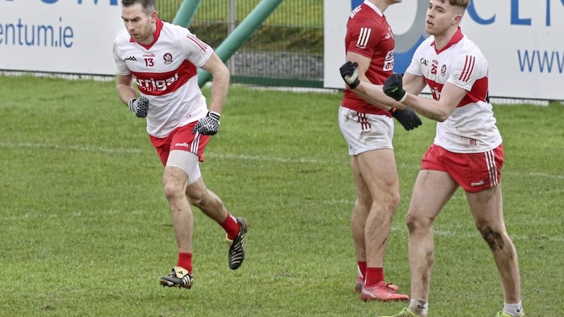 Derry's Benny Heron (13) wheels away after scoring the only goal against Cork during the NFL Division Two match at Owenbeg, with Oisin McWilliams (right) also celebrating.<br />Picture Margaret McLaughlin