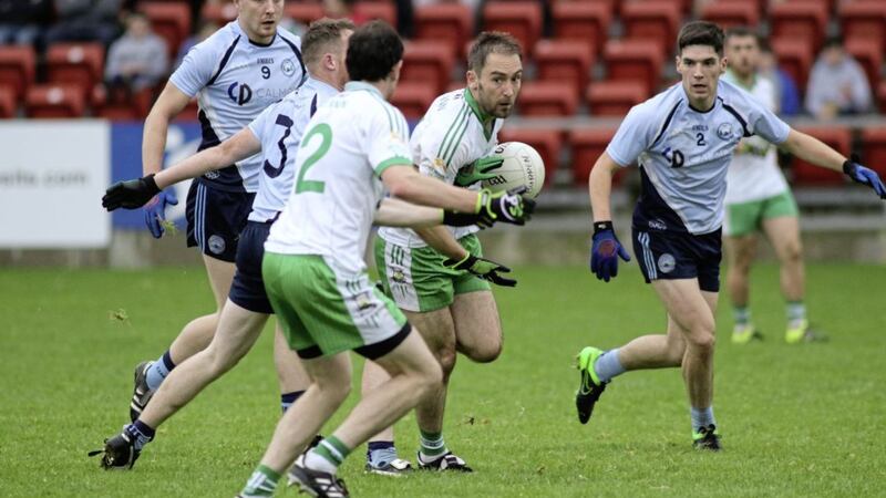 Sean Murdock of Burren is closed down by Mayobridge trio Conor Fitzpatrick (2), Jamie Barr (9) and Shane McNamee (3) Picture by Louis McNally 
