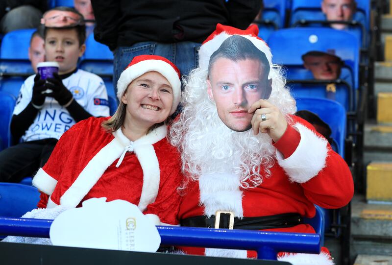 Fans in Santa Claus fancy dress and face masks of Leicester City's Jamie Vardy in the stands before the Premier League match at the King Power Stadium, Leicester