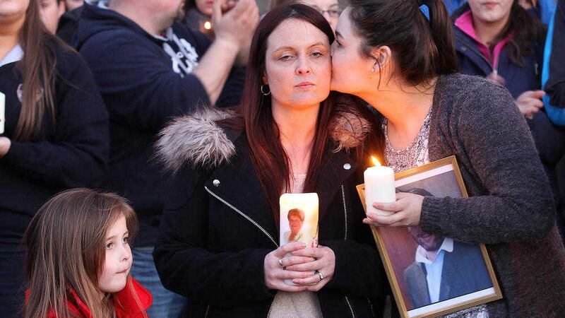 Joanne McGibbon being kissed by older daughter Seana at a vigil at Holy Cross Church in Ardoyne following the murder of her husband Michael in April 