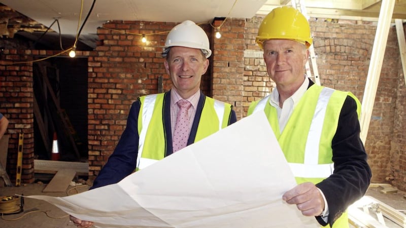 David Crowe and Kevin Baird look at the plans for their new easyHotel, due to open on Howard Street in Belfast city centre. Picture by Matt Bohill 