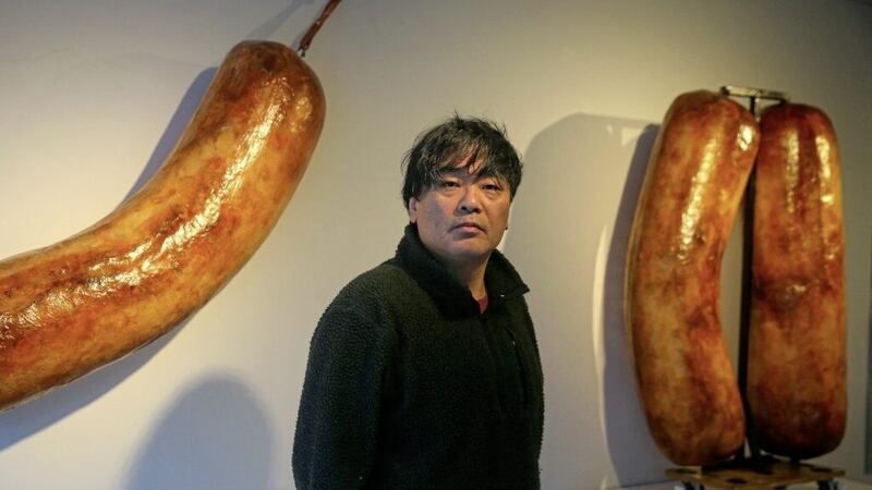 Artist Shiro Masuyama at his &quot;Brexit Sausage&quot; exhibitionin at the Cult&uacute;rlann in west Belfast. 
