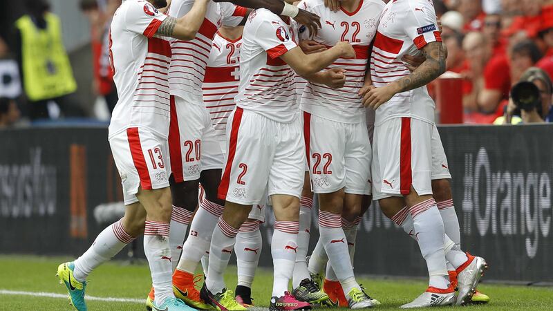 Switzerland's Fabian Schaer celebrates with teammates after scoring his side's first goal