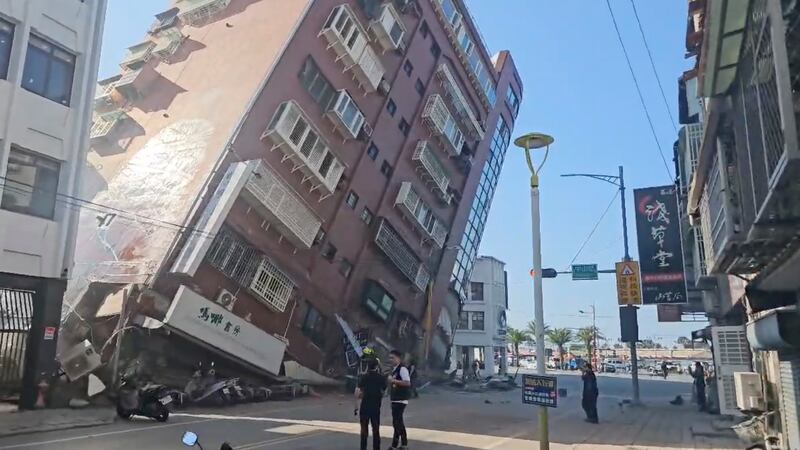 In this image taken from a video footage run by TVBS, a partially collapsed building is seen in Hualien, eastern Taiwan (TVBS/AP)