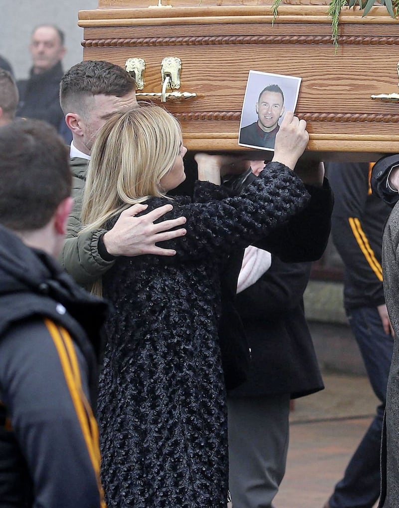 Lisa Colhoun, the widow of Christopher Colhoun, carried his photograph. Picture by Mal McCann 