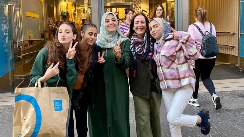 Pictured left to right; Pupils Yara, Malak, teacher Rinan (wearing green), St Louise's teacher Mairead Robb and pupil Rahaf shopping in Belfast in 2022. A fundraiser is now underway to help their families cross the border from Gaza into Egypt.