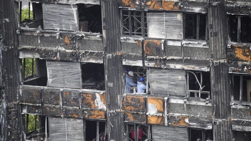 Work starts to cover the ruin of Grenfell Tower, nearly four months after a fire inflicted engulfed the high-rise block of flats in June last year 