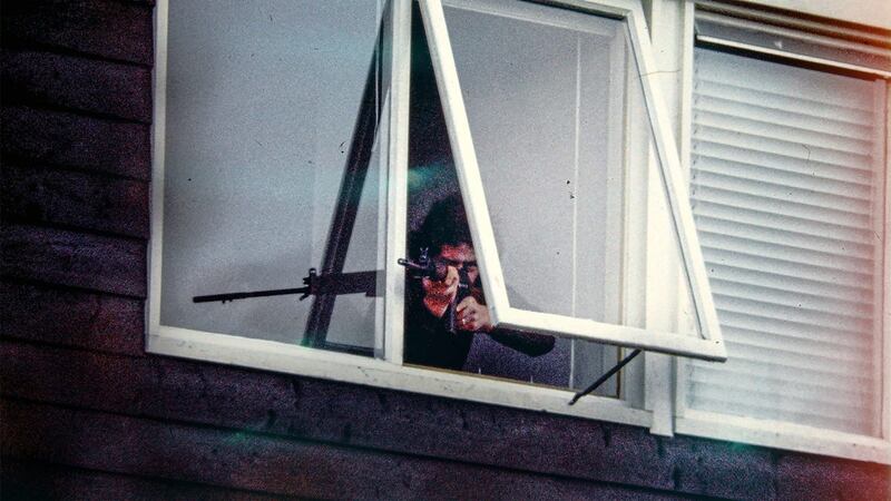 A still from the BBC programme The Secret Army showing a man with a gun pointing from a window