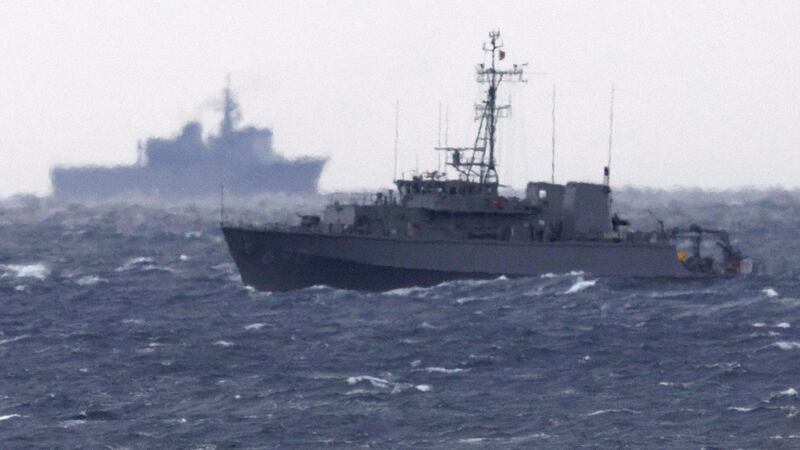 A Japanese ship searches in the waters where a military Osprey aircraft crashed (Kyodo News/AP)