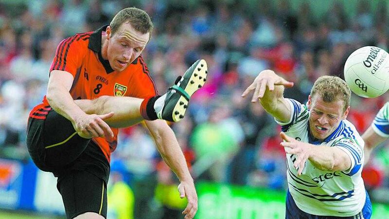 Former Monaghan captain Owen Lennon tries to block an effort from Down's Ambrose Rogers in what Lennon describes as his worst defeat in inter-county football <br />Picture by Colm O'Reilly