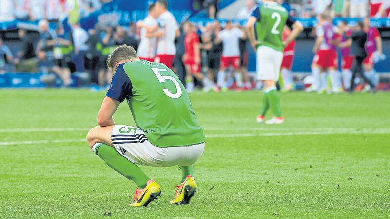 &nbsp;Jonny Evans cuts a disconsolate figure after Sunday&rsquo;s defeat to Poland but the Northern Ireland defender is determined to bounce back against Ukraine on Thursday<br/>Picture by PA