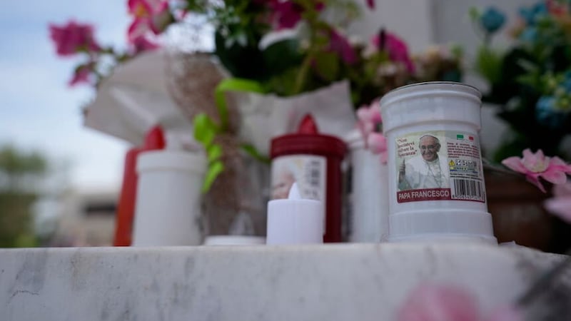 Candles with the image of Pope Francis are left at the entrance of the Agostino Gemelli University Polyclinic in Rome (AP)