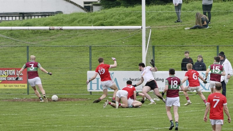 Dara Mooney scores the extra-time goal that sent Eoghan Rua on the road to victory over Magherafelt in Ballinascreen yesterday. Picture by Margaret McLaughlin. 