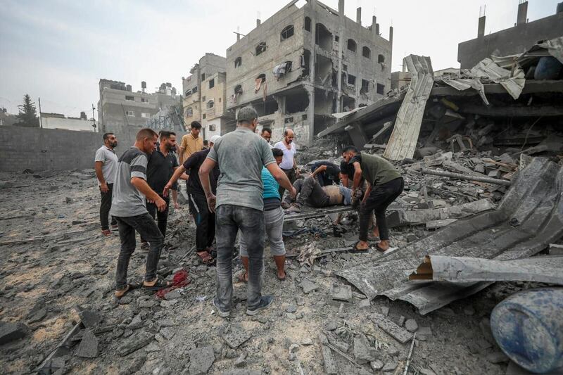 Palestinians evacuate the wounded following an Israeli aerial bombing on Jabaliya near Gaza City 