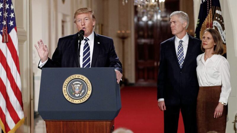 MAN IN COURT: President Donald Trump speaks in the East Room of the White House in Washington to announce Judge Neil Gorsuch as his nominee for the Supreme Court. Gorsuch stands with his wife Louise 			    Picture: Carolyn Kaster/AP 