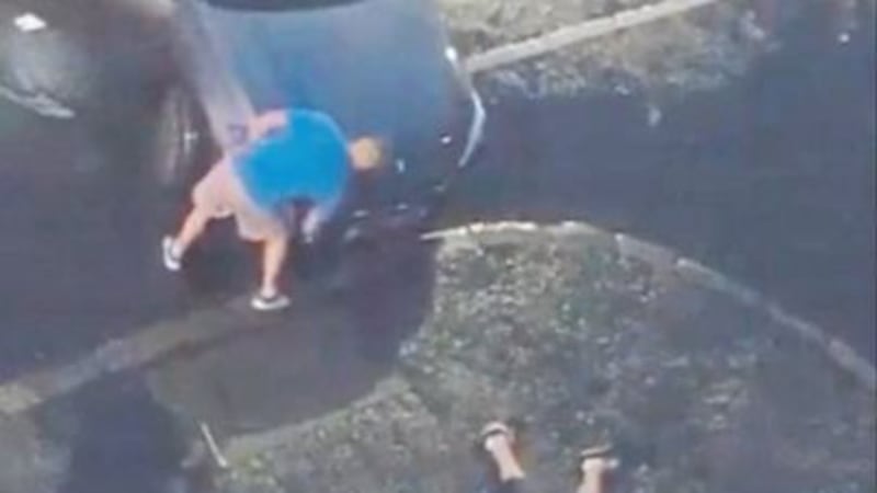 &nbsp;Footage from a video shared on social media shows a man on the ground while another man looks at his car