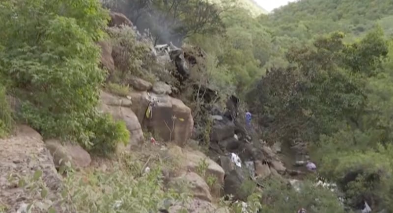 An image taken from video provided by eNCA shows the remains of the bus (eNCA/AP)