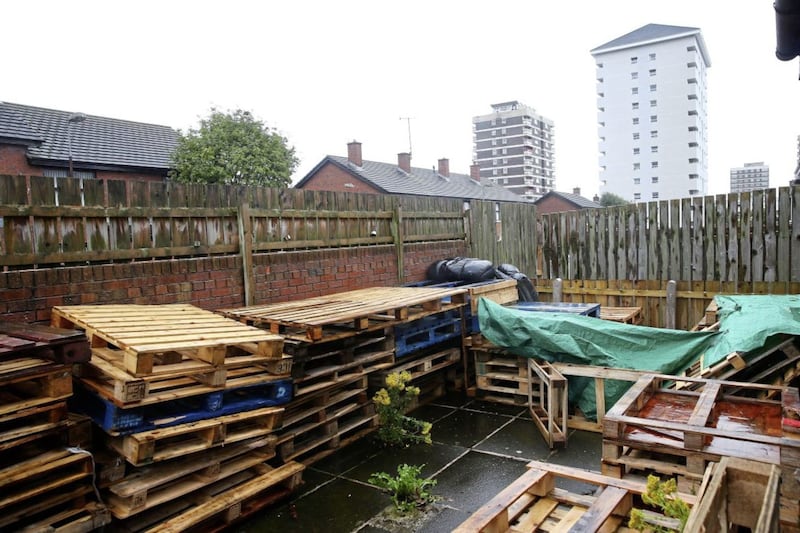 Wooden pallets being stored in the yard of a house in north Belfast&#39;s New Lodge area, close to a bonfire site 