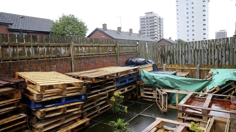 Wooden pallets being stored in the yard of a house in north Belfast&#39;s New Lodge area, close to a bonfire site 
