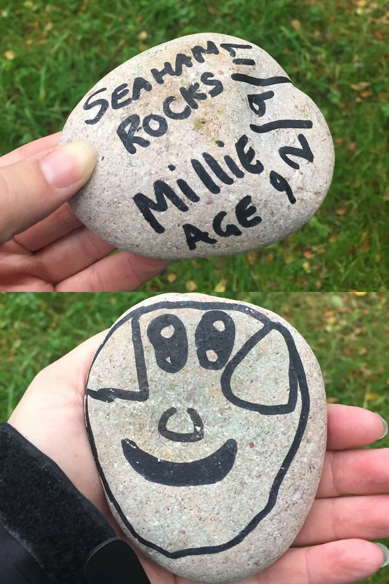 The two sides of a painted rock with sharing details. (PA)