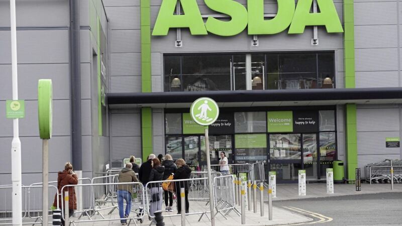 Shoppers queue at Asda on Kennedy Way, Belfast, on Sunday morning as laws were relaxed allowing larger shops to open from 10am instead of 1pm 