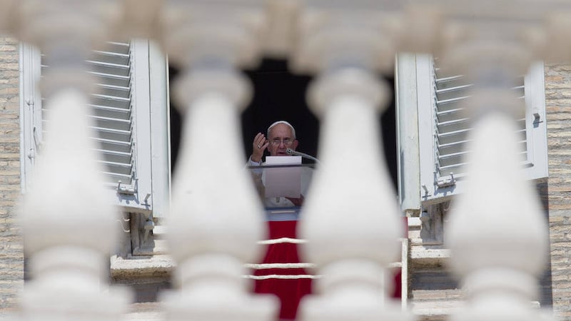 Pope Francis delivers his blessing as he celebrates the Angelus noon prayer from the window of his studio overlooking St. Peter&#39;s Square, at the Vatican yesterday. Pope Francis is urging people to work together to stop crimes against migrants, including the 71 who perished in the back of truck travelling the main Budapest-Vienna highway. (AP Photo/Andrew Medichini). 