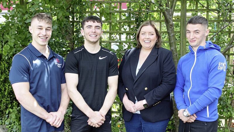Communities Minister Deirdre Hargey pictured with gymnasts (l-r) Ewan McAteer, Eamon Montgomery and Rhys McClenaghan 