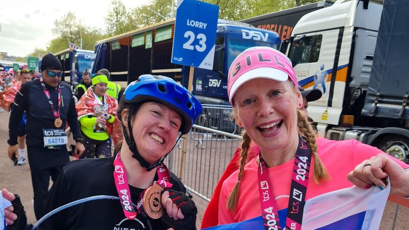 Dr Julie McElroy (left) completed the London Marathon in five hours and 59 minutes on Sunday, accompanied by her support runner Gill Menzies (right)