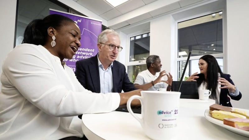 Pictured at Advice NI in Belfast is George Higginson from Bank of Ireland UK, hearing about the Advice NI Digi Money Programme from Dr Anne Rice, digital inclusion co-ordinator at Advice NI, with Esther Ogunleye and Agrippa Njanina, Advice NI digital champions. Advice NI is one of 68 community organisations to receive financial support through the Begin Together programme. Picture: Kelvin Boyes/PressEye 