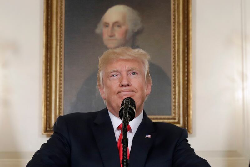 Trump in front of a picture of George Washington